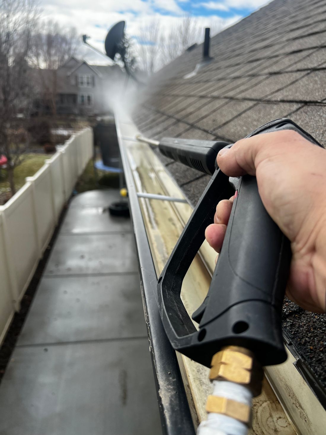Gutter cleaning with a pressure washer in Sandy Springs, GA